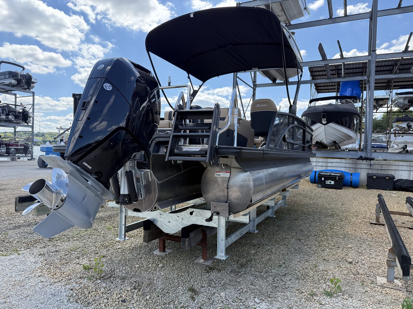 Pontoon boat stored on a galvanized steel Veeline cradle at a marina